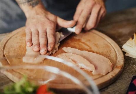 chef cutting up chicken