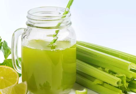 Celery juice and celery stalk on white background