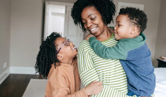 Happy mom juggling two kids