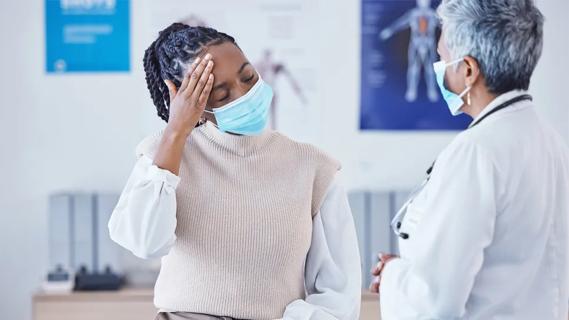 Masked patient with physician