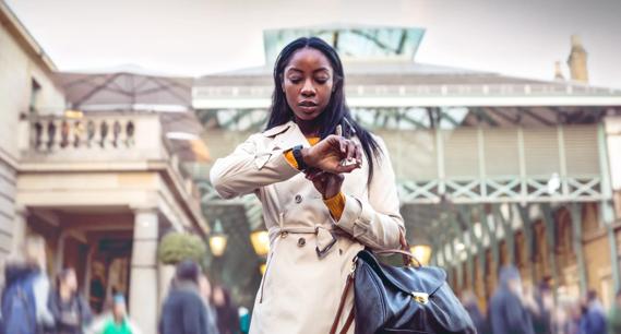 Person checking watch at a rail station