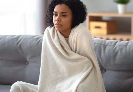 woman wrapped in blanket cold