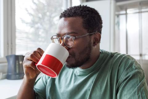 Person drinking from a coffee mug