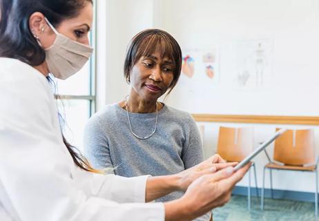 A medical professional and female patient talking