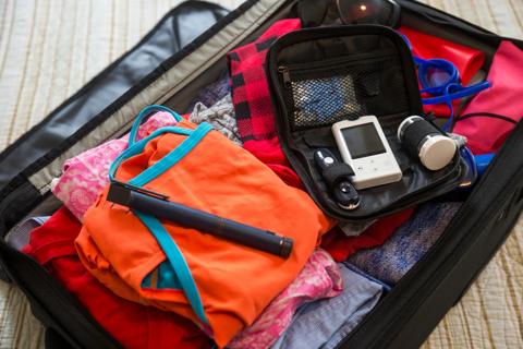 Diabetes medical test and devices in a suitcase with clothing