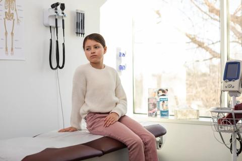 Young girl on a medical exam bench