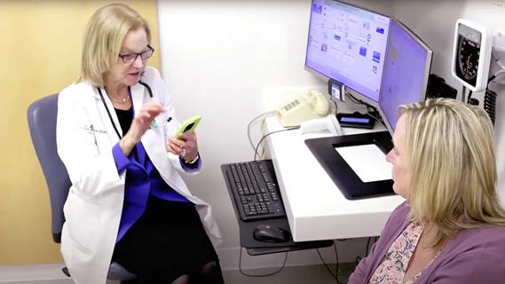 Doctor using AI scribing tool during patient meeting