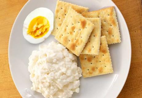 plate of cottage cheese, 5 saltine crackers, and a hard boiled egg