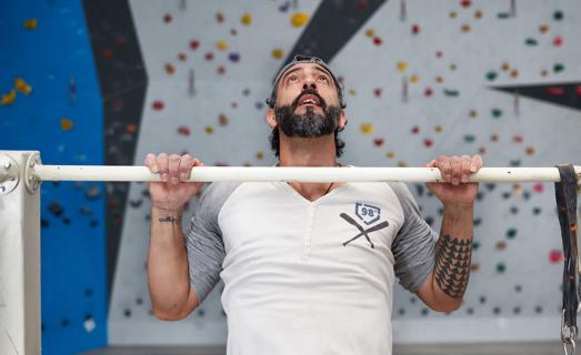 Person doing overhand pull up at gym