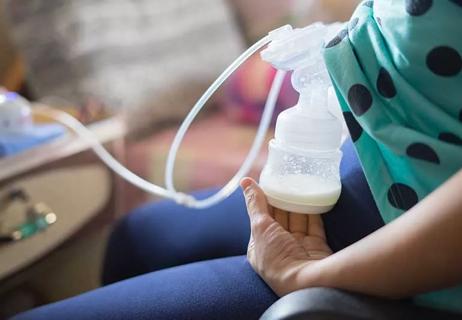 woman using breast pump