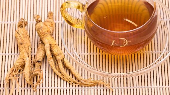 Giseng root and ginseng tea on reed mat