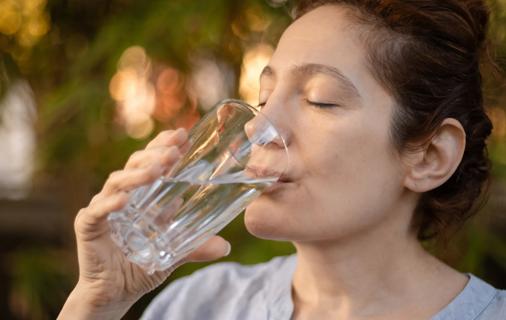 Person drinking a glass of water