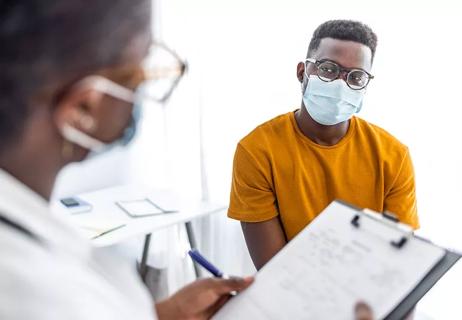 Physician talks to patient during appointment.