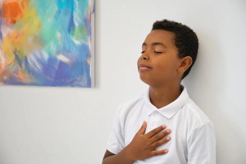 Child practicing breathwork