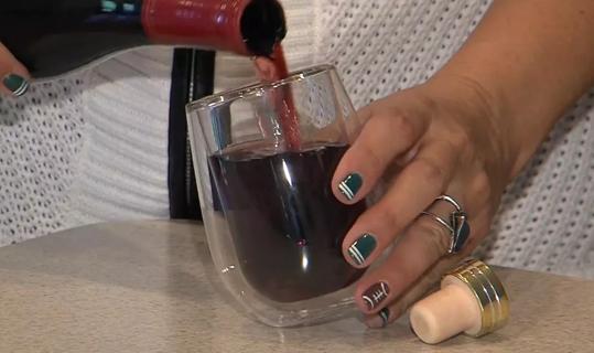 Woman pouring glass of wine.