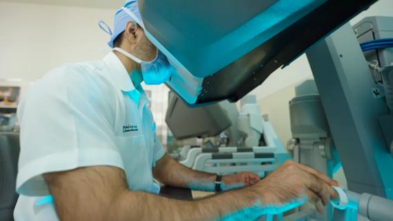 Dr. Usman Ahmad using a surgical robot.