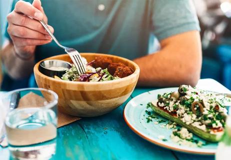 man eating meatless salad