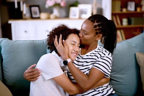 Teen and parent embracing