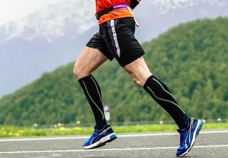man running while wearing compression socks