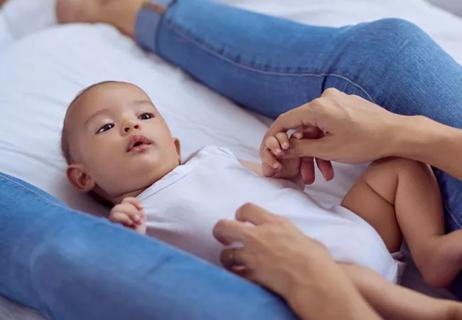 Female embracing young child.