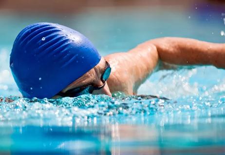 elderly woman swims in pool