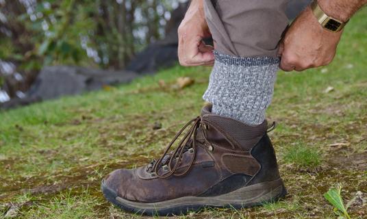 Hands tucking pant legs into socks