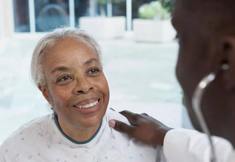 Elderly woman visits with her doctor for a checkup