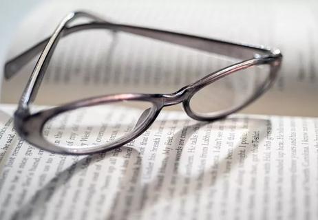Reader glasses placed on a book