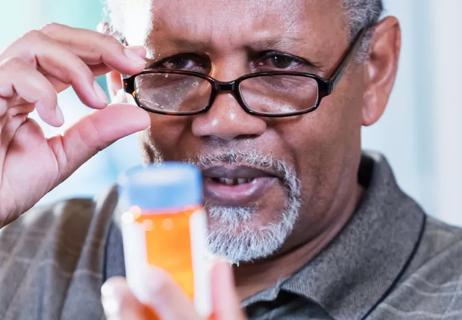 man using cheater eyeglasses to read