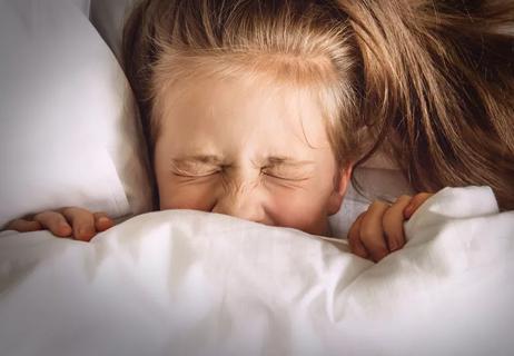 child frightened in bed with night terrors