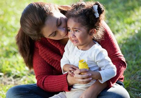 mother consoling crying two year old