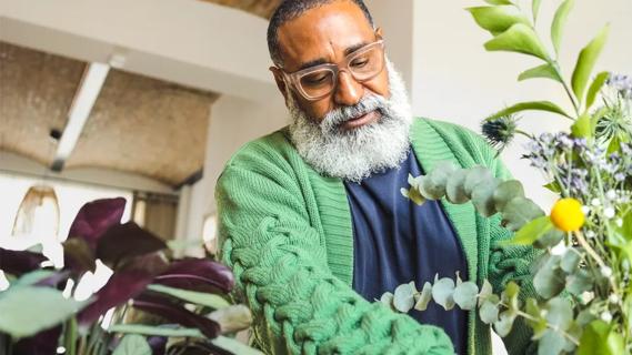 Older man tending to houseplants