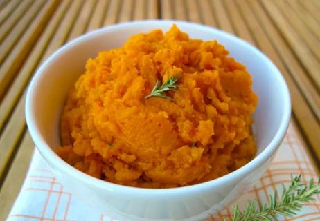 A bowl of rosemary garlic mashed sweet potatoes.