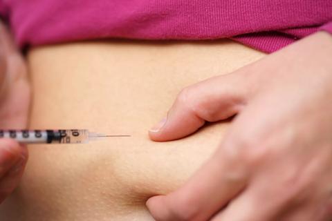 person injecting insulin