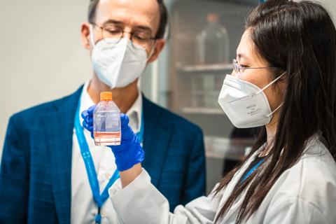Jos Melenhorst PhD, in his research lab with an associate. With mask.