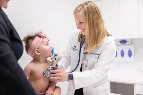 Dr. Townsend examining a toddler after heart transplant