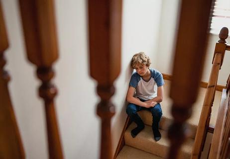 Teen sitting alone on staircase