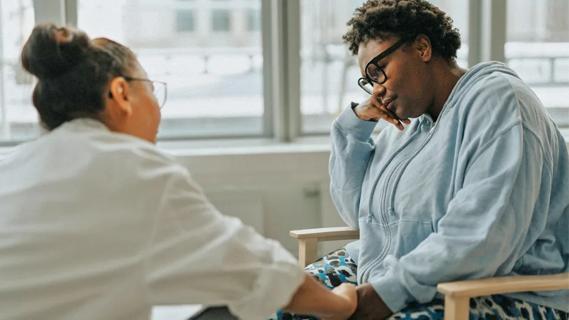 Physician comforting patient