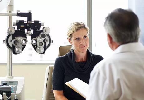 Female patient in eye examination room with doctor