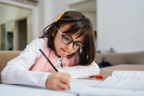 Child working on school writing assignment