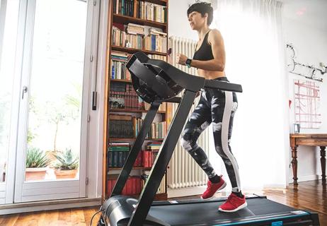 A person working out on a treadmill in their home