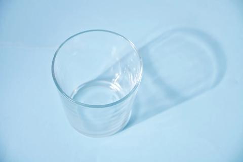 Empty glass on blue table