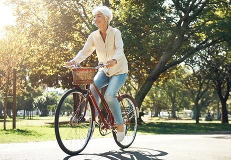 woman with osteoarthritis biking for exercise