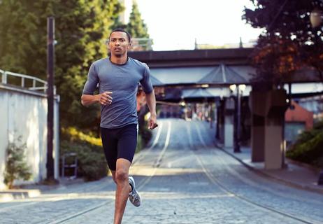 man running alone down a city street