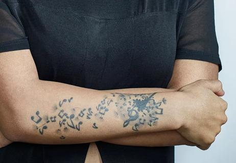 woman with tattoos on arm