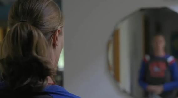 Woman looking into mirror