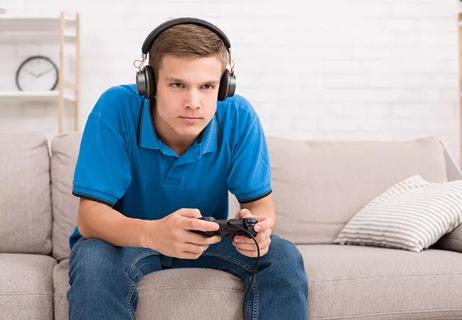Teenager playing video games