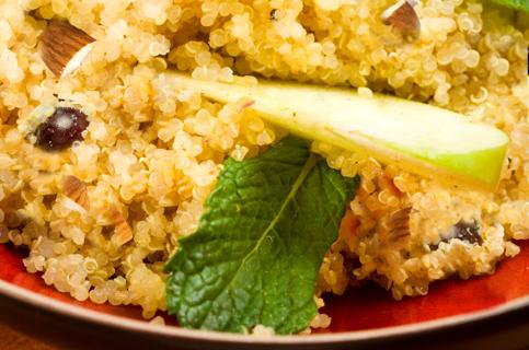 A plate of quinoa with apples, mint leaves and almonds