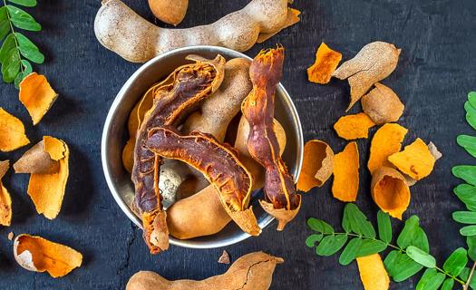 Bowl of partially peeled tamarind