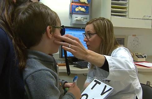 Doctor examining child's eyes